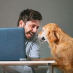 Man working at home with his dog
